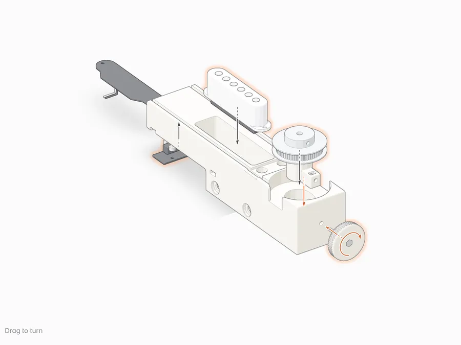 The tail block on the bench: the pickup comes down into its bay and the endstop board up into its pocket; the idler sled goes down through the idler well into its pocket; the knob and its screw come in through the end wall and turn a few turns into the nyloc; the idler pulley goes down onto its shaft.